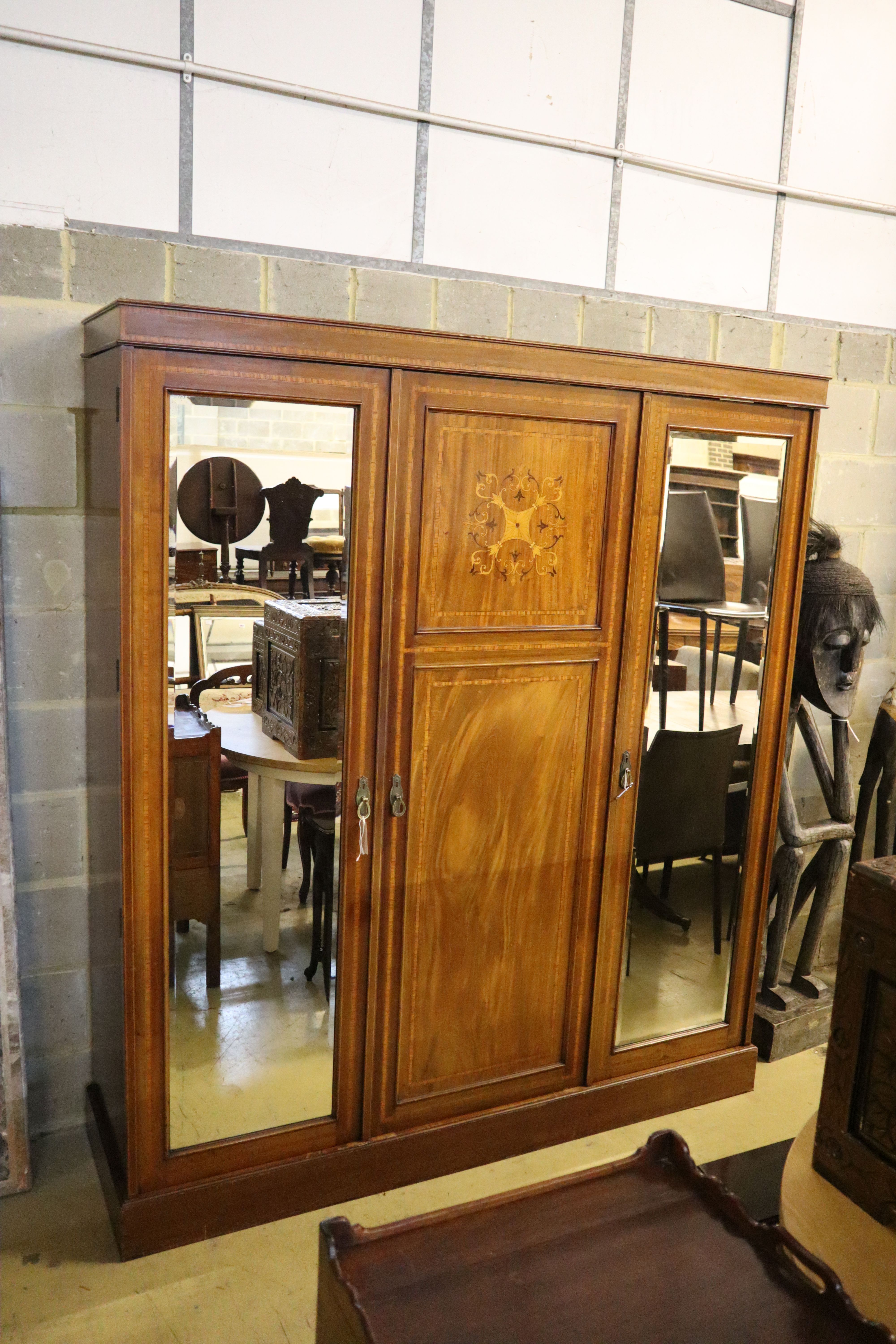An Edwardian satinwood banded and inlaid mahogany triple wardrobe with fitted interior, width 175cm, depth 50cm, height 200cm
